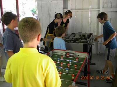 Teens play Foosball before dinner