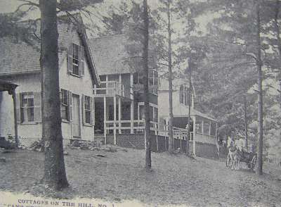 Horse drawn wagon passes cottages 