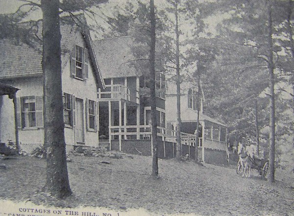 Horse drawn wagon passes cottages